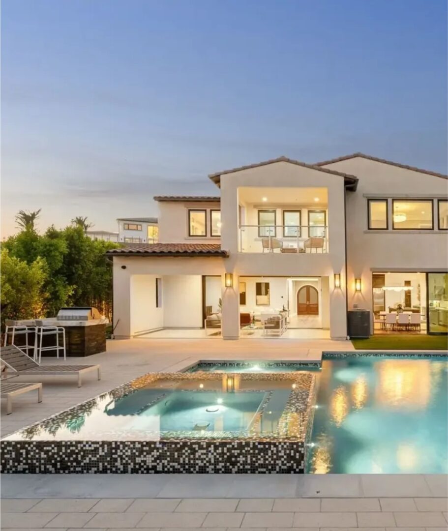 Modern house with pool at sunset.
