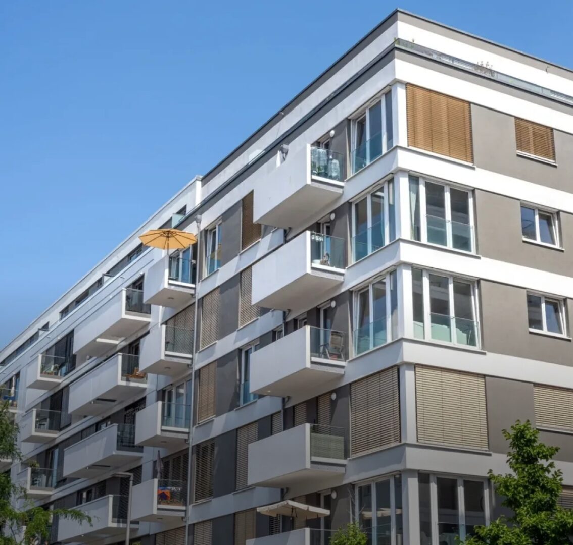 Modern apartment building with balconies and windows.