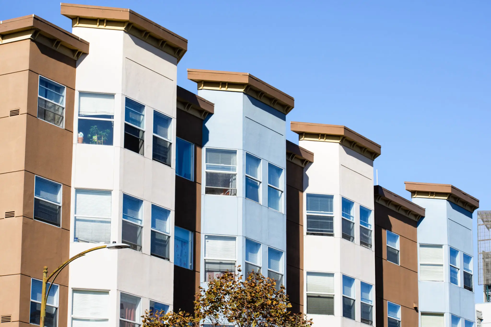 Modern apartment buildings with blue sky background.