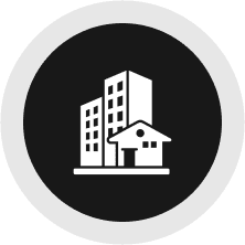 Icon of buildings on black circular background.