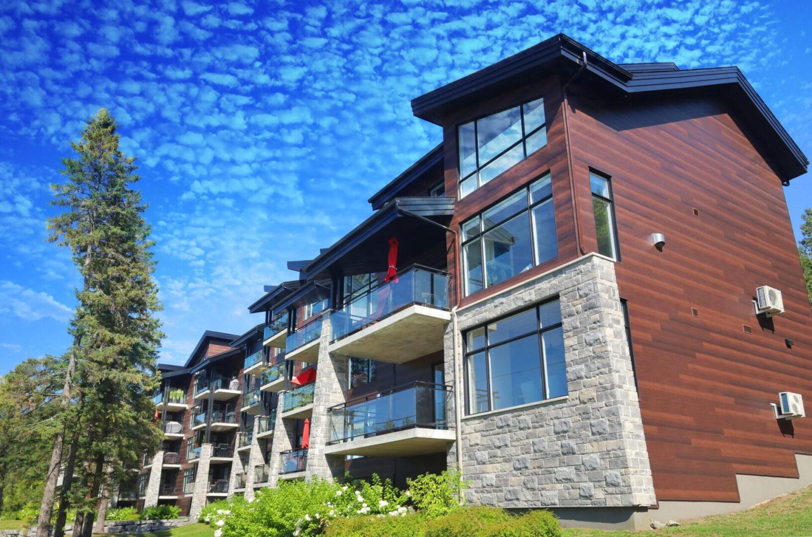 Modern apartment building with blue sky backdrop.