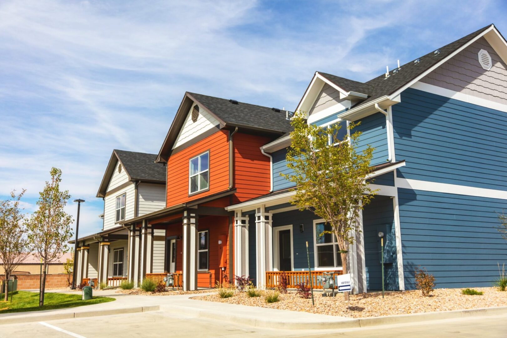 Colorful modern townhouses under a clear sky.