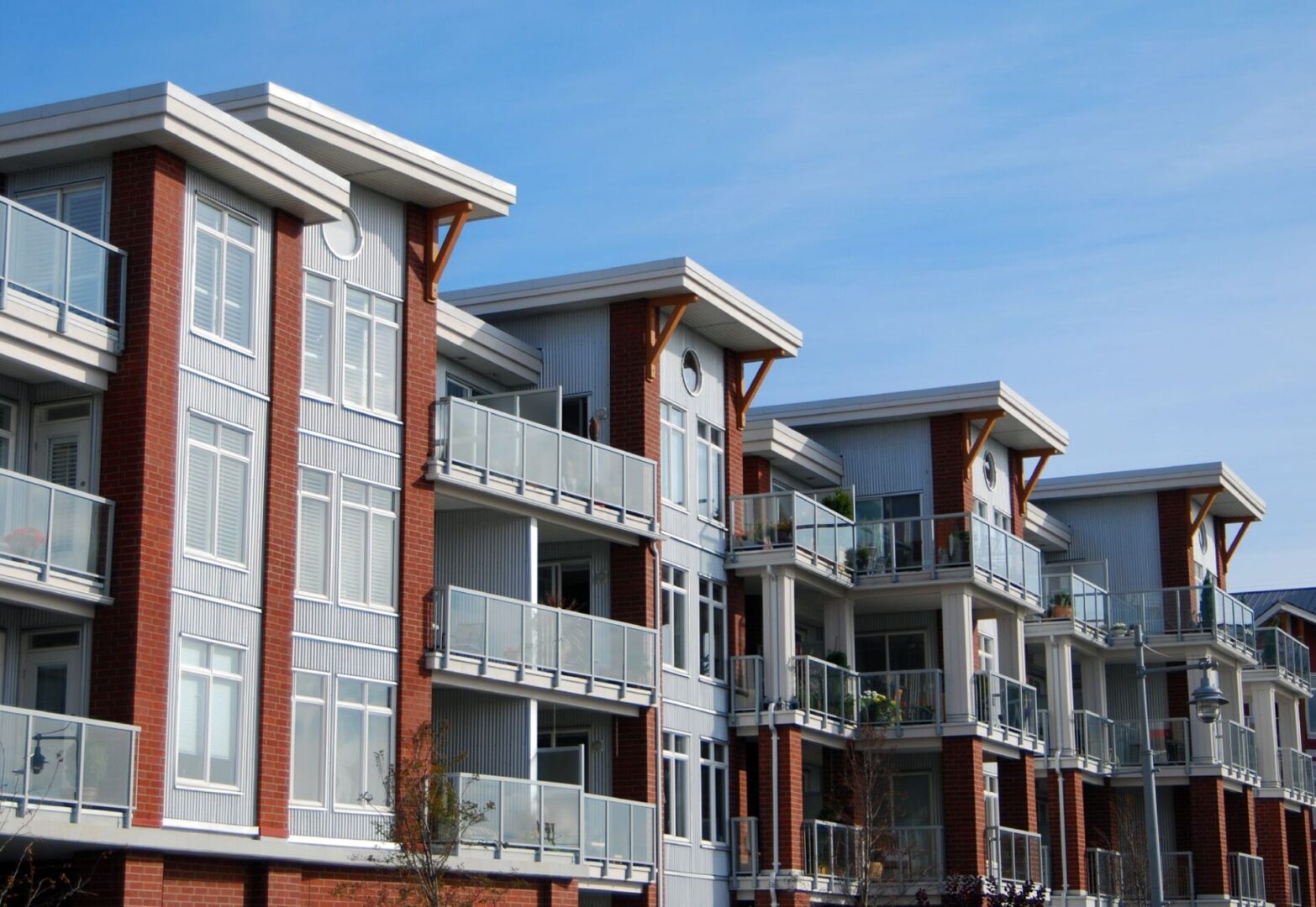Modern apartment building with glass balconies.